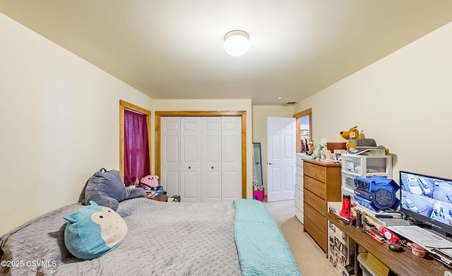 bedroom featuring a closet and light colored carpet