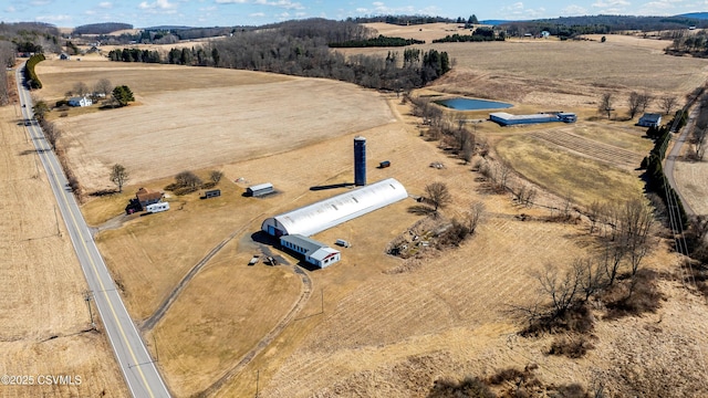 birds eye view of property with a rural view