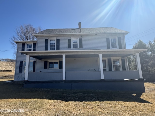 view of front of home with a porch and a front lawn