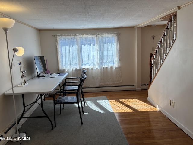 unfurnished office featuring baseboards, wood finished floors, and crown molding