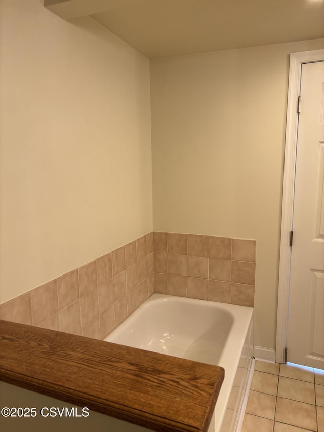 bathroom with a bath and tile patterned flooring