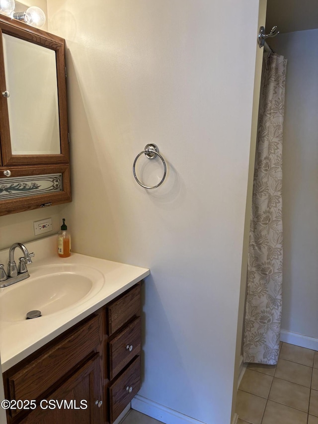 bathroom featuring tile patterned floors, baseboards, a shower with curtain, and vanity