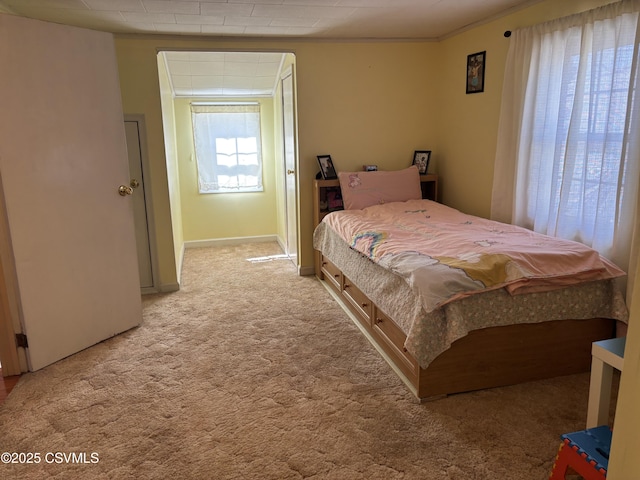 bedroom featuring light colored carpet and baseboards