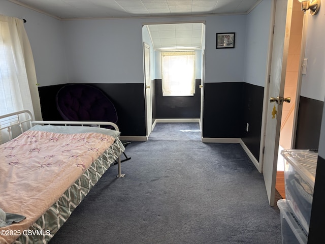 carpeted bedroom featuring baseboards and ornamental molding