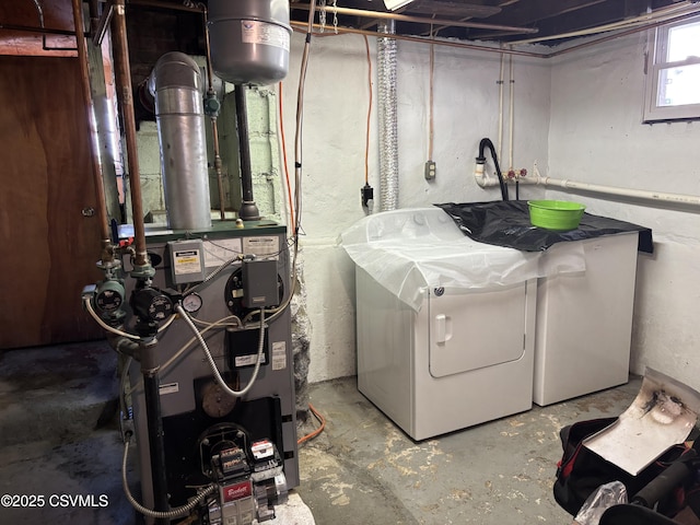 clothes washing area with laundry area, washer and dryer, and a heating unit