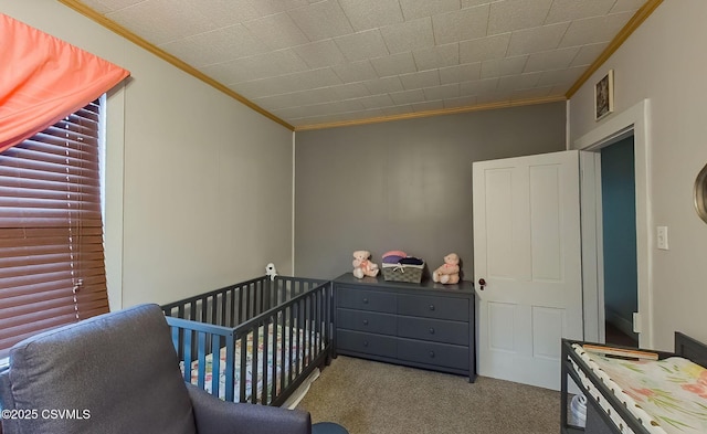 carpeted bedroom with a crib, visible vents, and ornamental molding