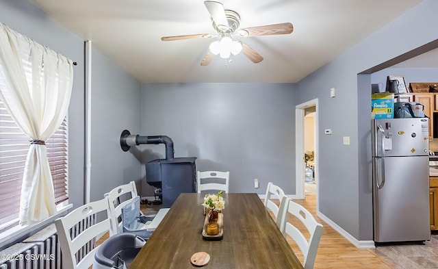 dining area featuring baseboards and ceiling fan