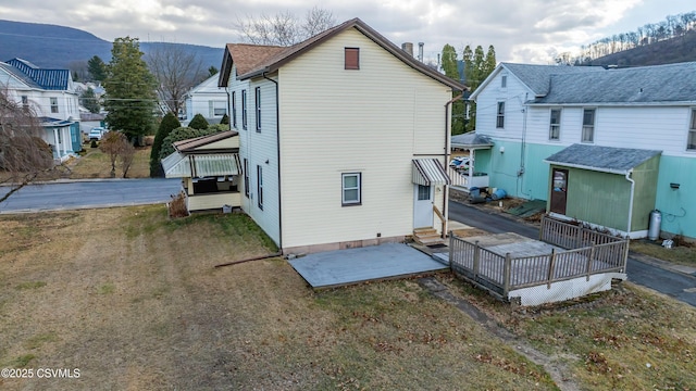 back of property with entry steps, a mountain view, and a residential view