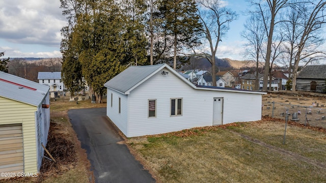 view of outdoor structure with a mountain view and driveway