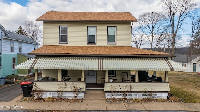 view of front of home with a porch and roof with shingles