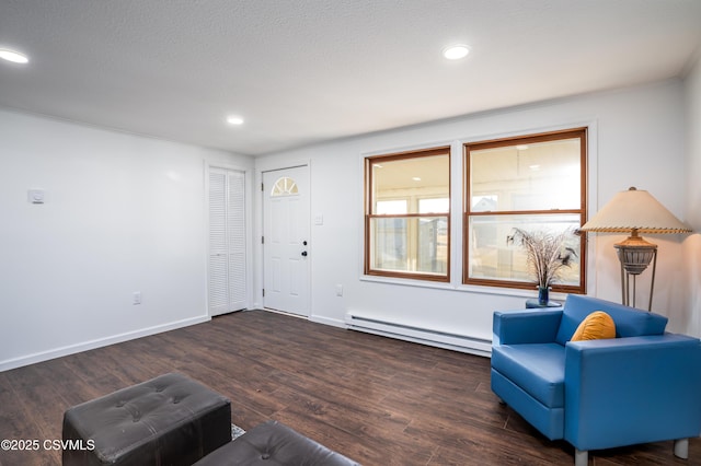 interior space featuring recessed lighting, wood finished floors, baseboards, and a baseboard radiator