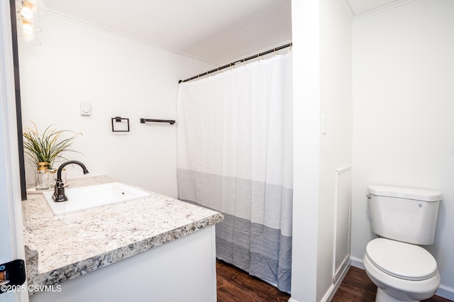 bathroom with a shower with curtain, toilet, wood finished floors, and ornamental molding