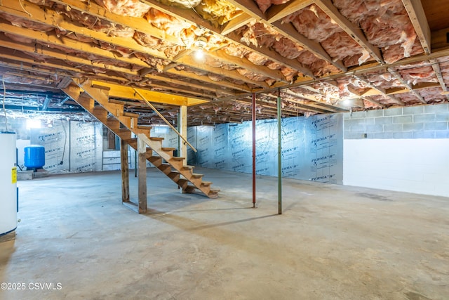 unfinished below grade area with gas water heater and stairs