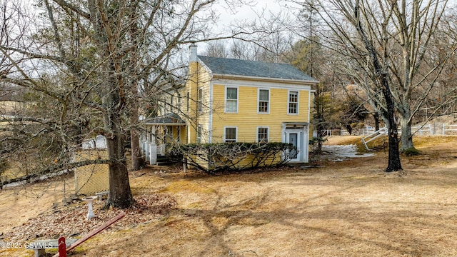 colonial inspired home featuring a chimney