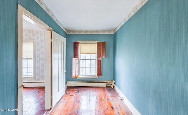 575 Crestwood Dr, Bloomsburg, PA 17815 - empty room featuring a baseboard radiator, baseboards, hardwood / wood-style flooring, and wallpapered walls