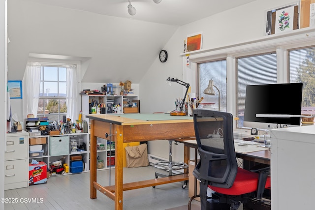 home office with vaulted ceiling and wood finished floors