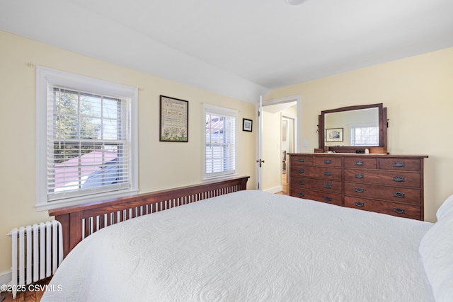 bedroom featuring radiator and vaulted ceiling