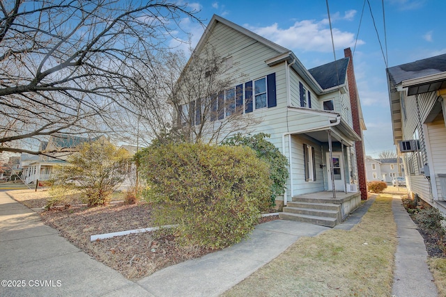 view of front of property with a porch and a chimney