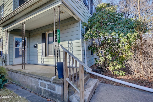 view of exterior entry with covered porch