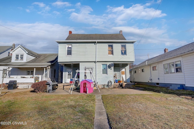 rear view of house with a patio area and a yard