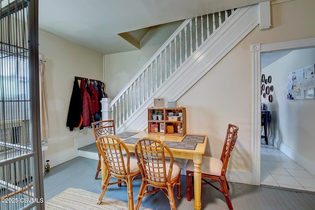 dining room featuring stairway and baseboards