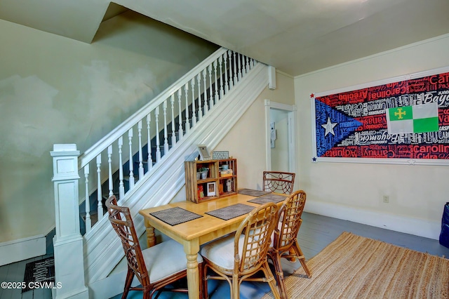 dining space with stairs and wood finished floors