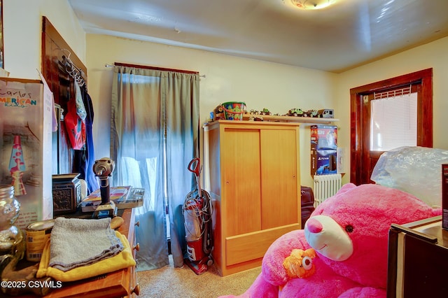 carpeted bedroom with radiator heating unit