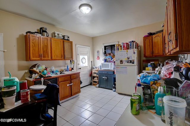 kitchen featuring light tile patterned floors, white appliances, brown cabinets, and light countertops