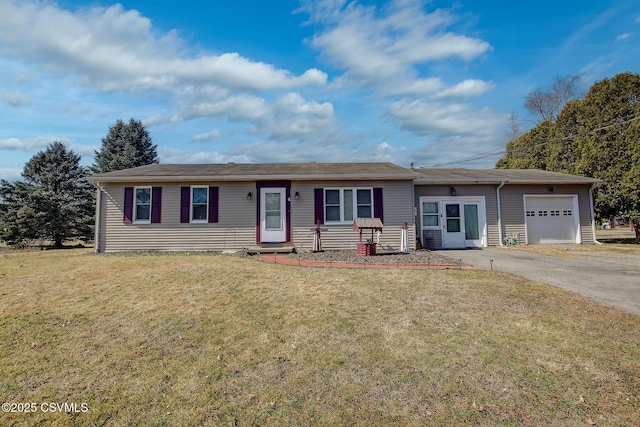 ranch-style home featuring an attached garage, driveway, and a front lawn