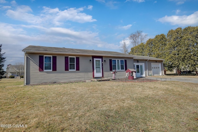 single story home featuring entry steps, a front yard, concrete driveway, and a garage