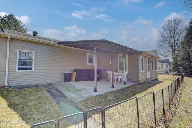 rear view of house with a patio, a fenced backyard, and a lawn