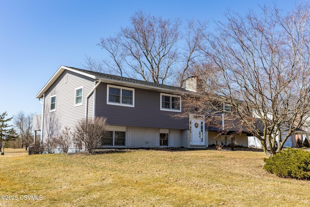 split foyer home with a front yard and a chimney