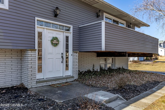 property entrance with brick siding