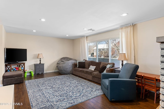 living area with dark wood finished floors, visible vents, and recessed lighting