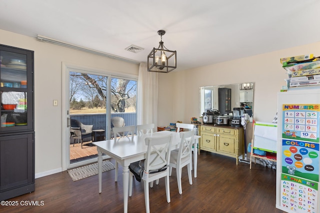 dining area with visible vents, baseboards, dark wood-type flooring, and a chandelier