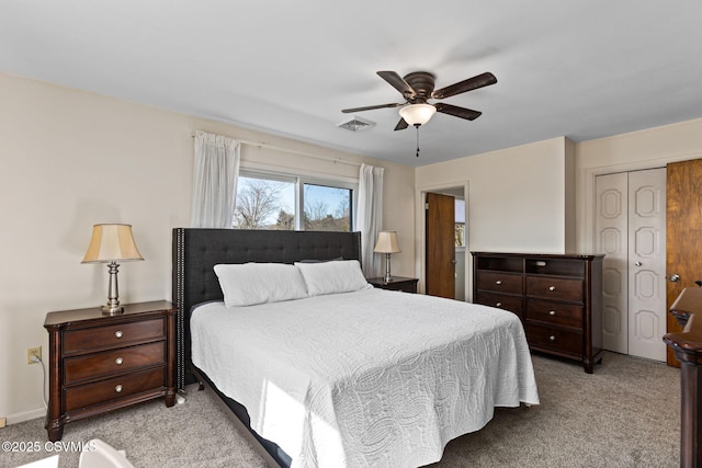 bedroom featuring visible vents, light colored carpet, a closet, and ceiling fan