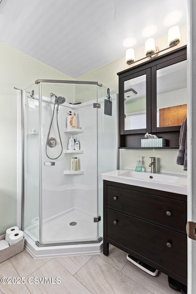 bathroom featuring a stall shower and vanity