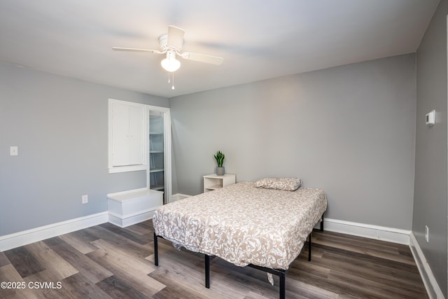 bedroom featuring wood finished floors, baseboards, and ceiling fan