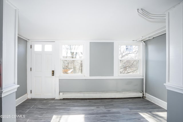 entryway with baseboard heating, baseboards, and wood finished floors