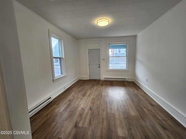 foyer featuring a baseboard heating unit, dark wood-type flooring, and baseboards