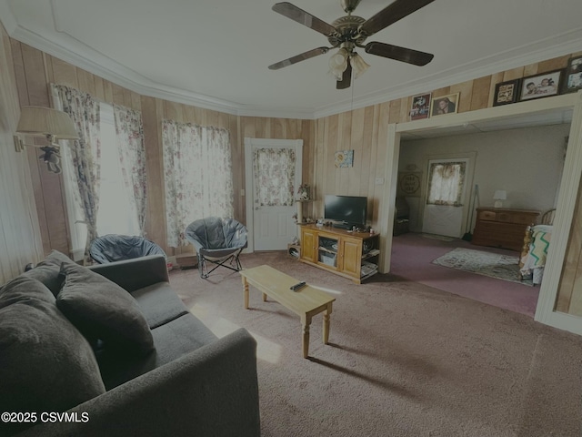 living area featuring crown molding, a ceiling fan, and light carpet