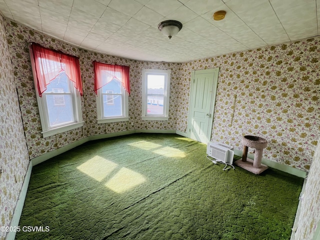 carpeted spare room with baseboards and wallpapered walls