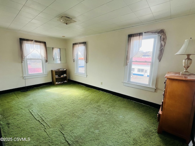 carpeted empty room with baseboards and ornamental molding