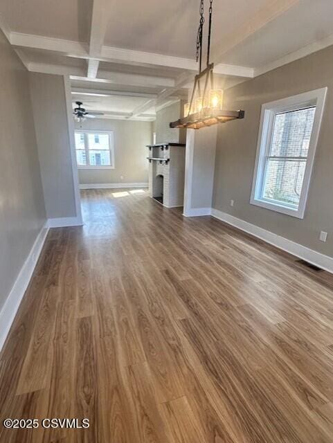 interior space featuring visible vents, baseboards, dark wood finished floors, beam ceiling, and ceiling fan