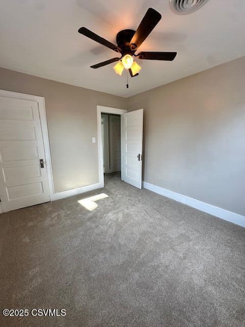 unfurnished bedroom featuring visible vents, a ceiling fan, baseboards, and carpet floors