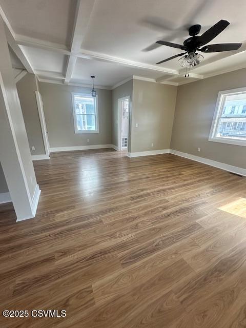 spare room with coffered ceiling, wood finished floors, crown molding, baseboards, and ceiling fan