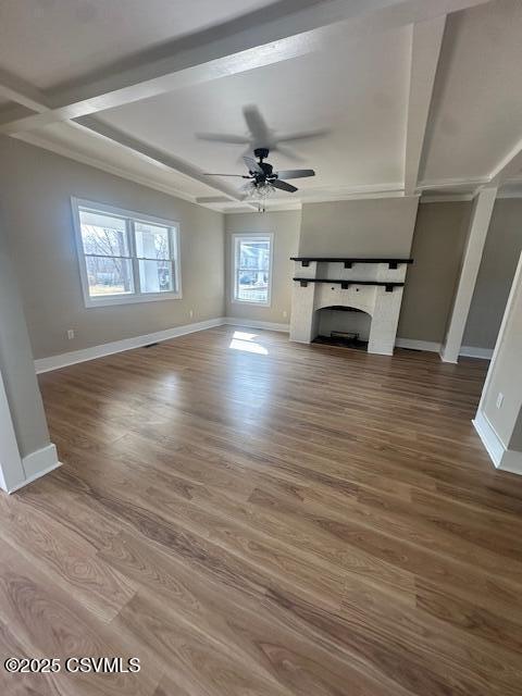 unfurnished living room with ceiling fan, a fireplace, baseboards, and wood finished floors