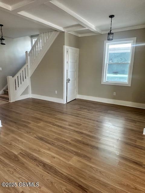 interior space with stairs, wood finished floors, and baseboards