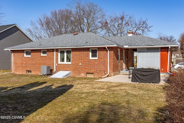 back of house with a yard, central AC, a shingled roof, a patio area, and brick siding