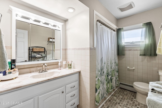 bathroom featuring visible vents, baseboard heating, tile walls, and toilet